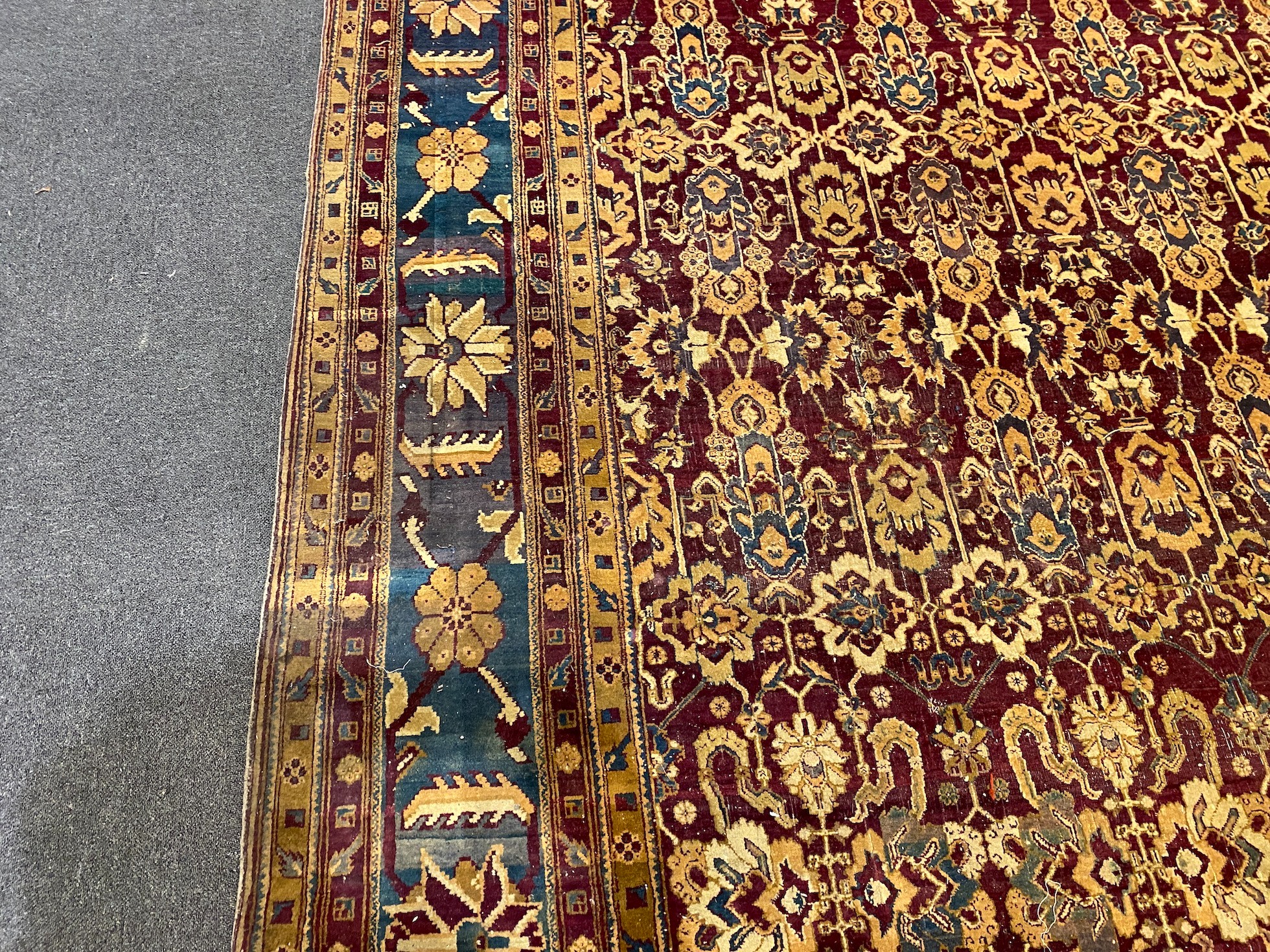 A large Sarouk purple ground carpet, approx. 20ft x 12ft. (cut in one area)